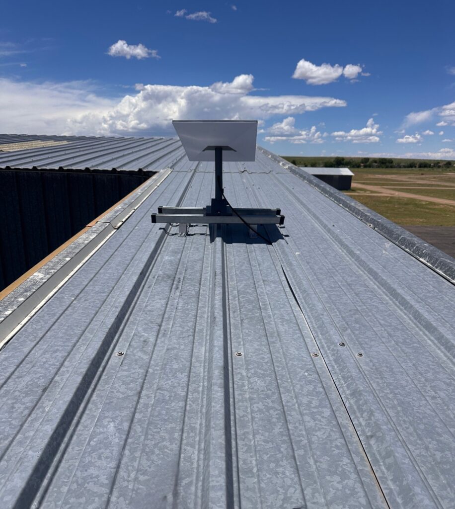 Starlink rooftop installation on warehouse metal roof